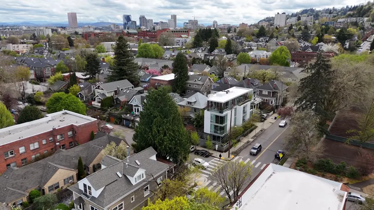 Aerial view of historic homes with downtown Portland in the distance