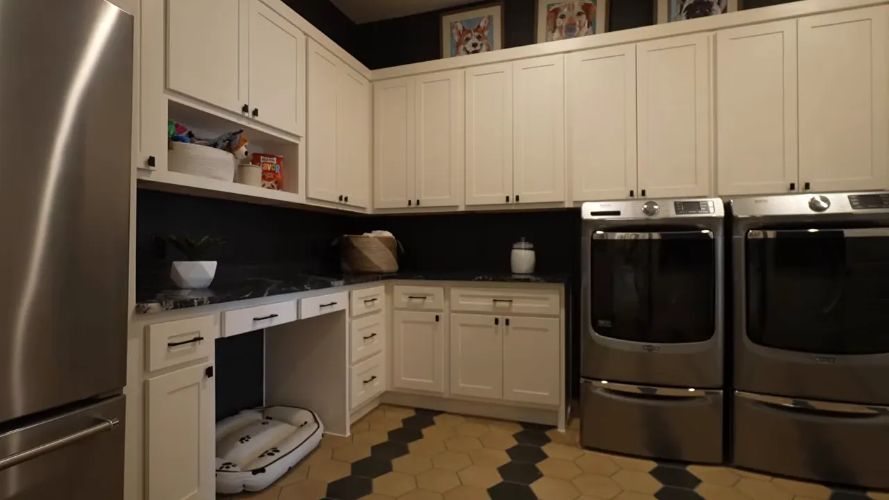 Large laundry room with cabinets counters refrigerator and double washers and dryers