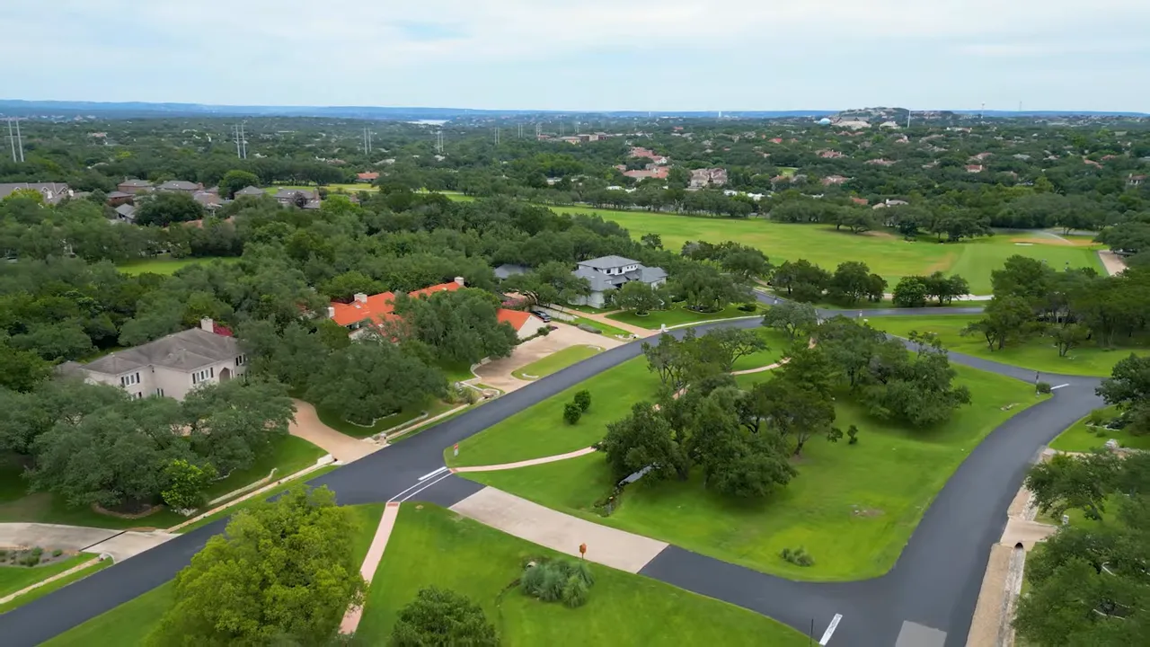 Aerial view of Lakeway Texas neighborhood roads, green space, and homes