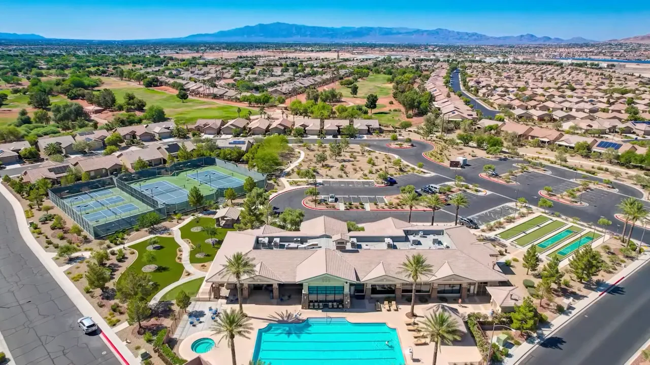 Aerial view of Solera clubhouse with pool tennis courts and nearby homes