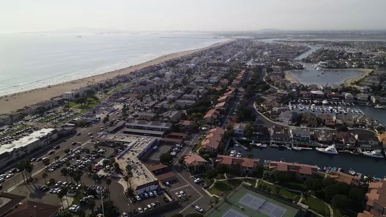 Coastal neighborhood aerial with on screen text lifestyle driven buyers