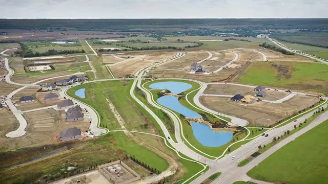 Aerial view of roads lakes homes and undeveloped land in a growing community