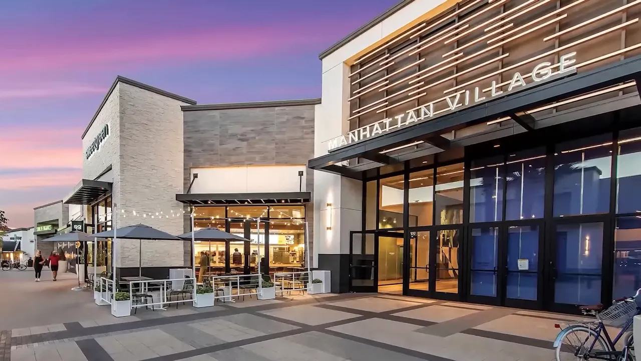 Exterior of Manhattan Village shopping center entrance at dusk