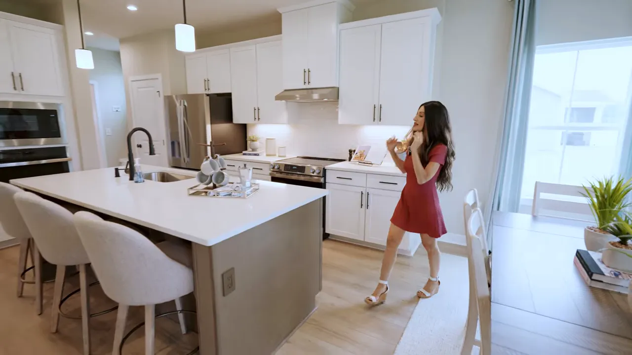 open kitchen with island stools pendant lights dining area and sliding doors