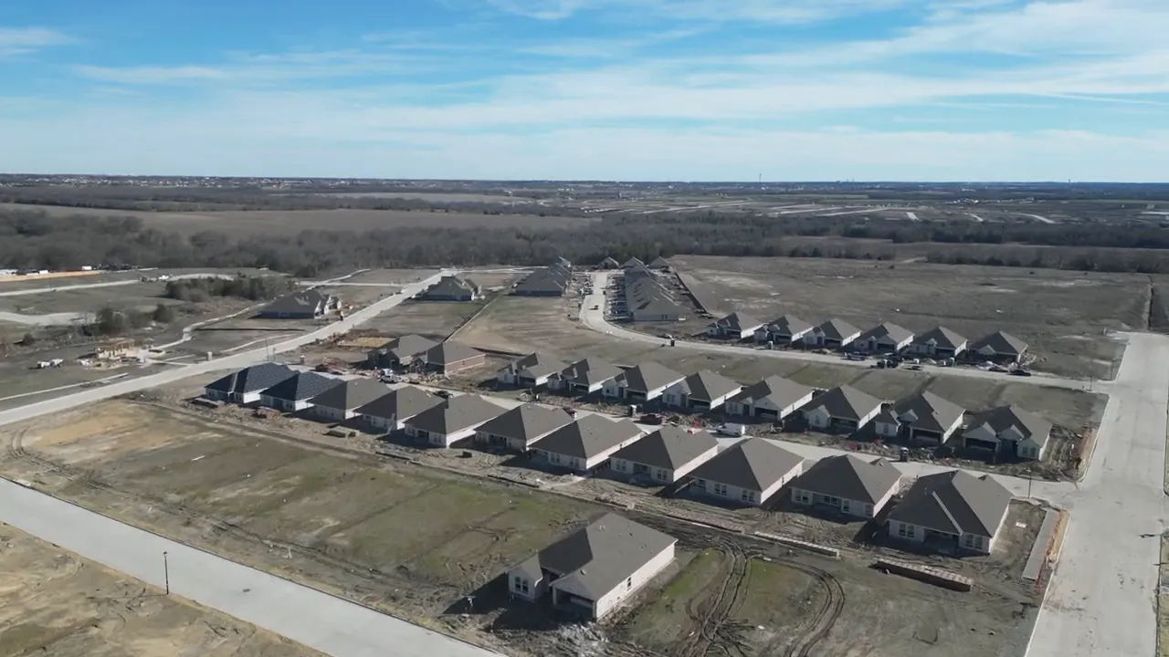 high clarity aerial photo showing rows of completed houses and ongoing construction in the Elevon community, Lavon TX