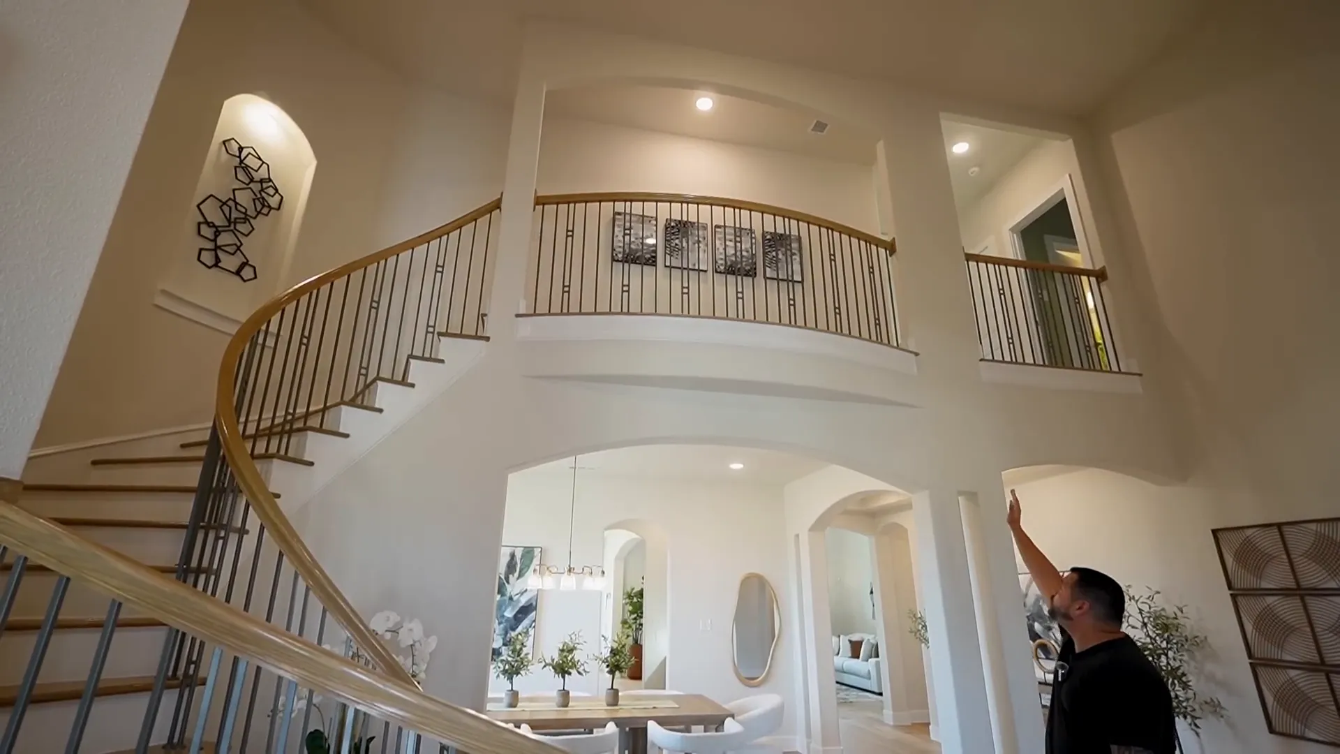 Grand entrance with beautiful curved staircase and bowed out Juliet balcony