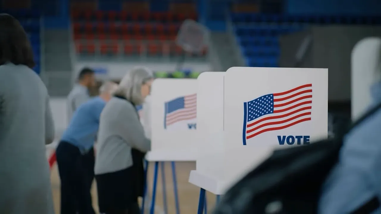 voting booths with American flags and people casting ballots