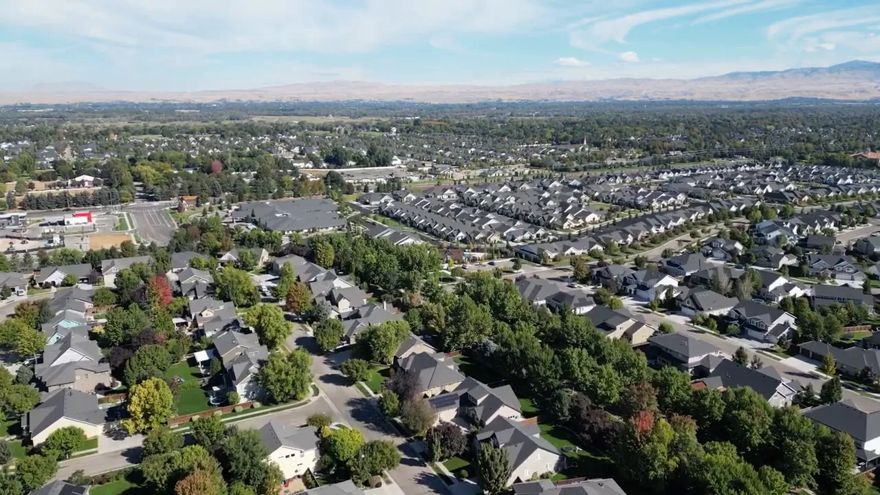 Aerial view of suburban neighborhoods and green trees in the Treasure Valley