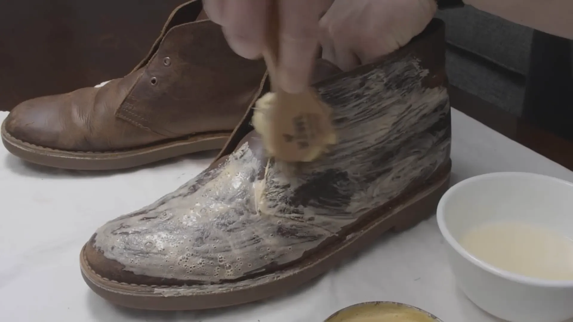 Applying saddle soap to the leather boots