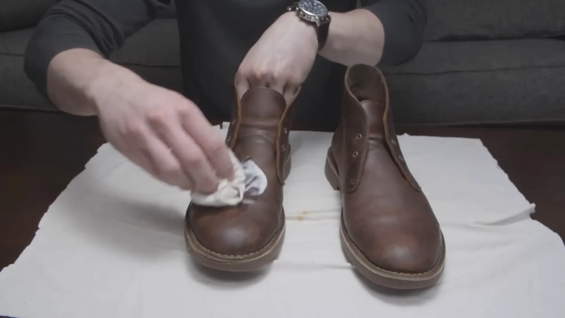 Applying leather conditioner to the boots