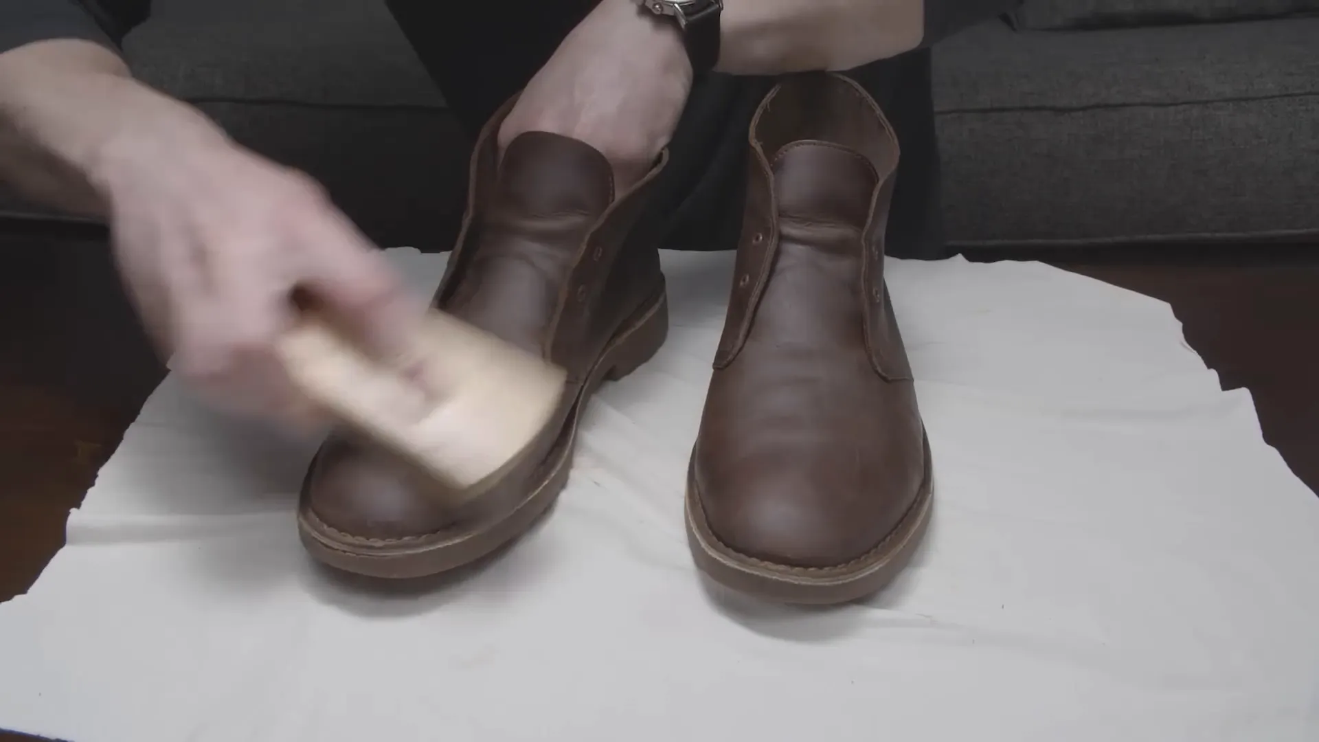 Applying cream polish to restore color to the boots