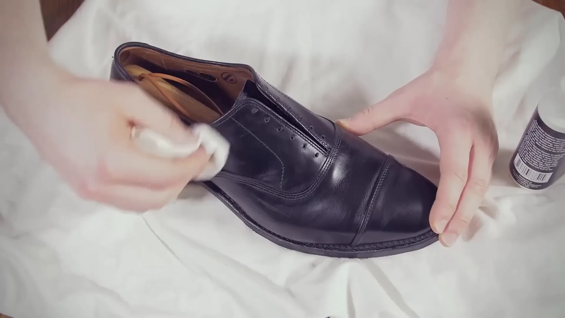 Applying conditioner on leather boots