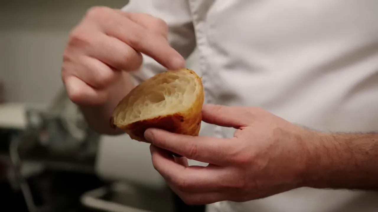 Cross section of baked croissant showing honeycomb interior