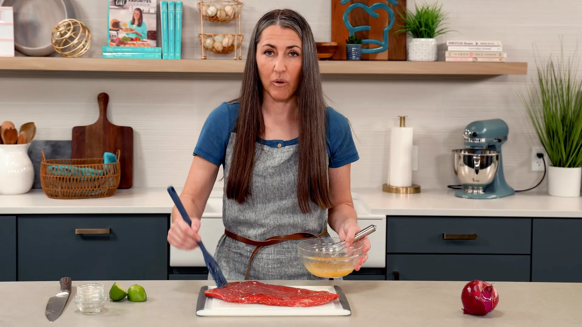 Brushing marinade onto steak before grilling