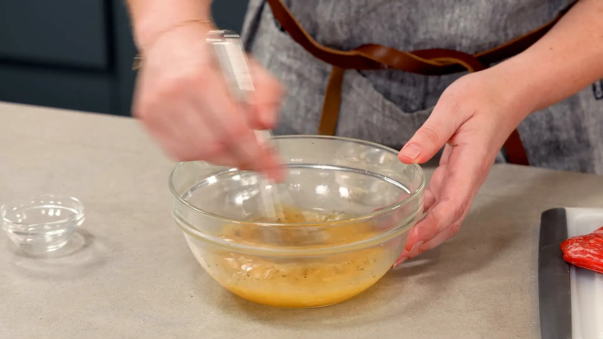 Whisking marinade ingredients in a bowl