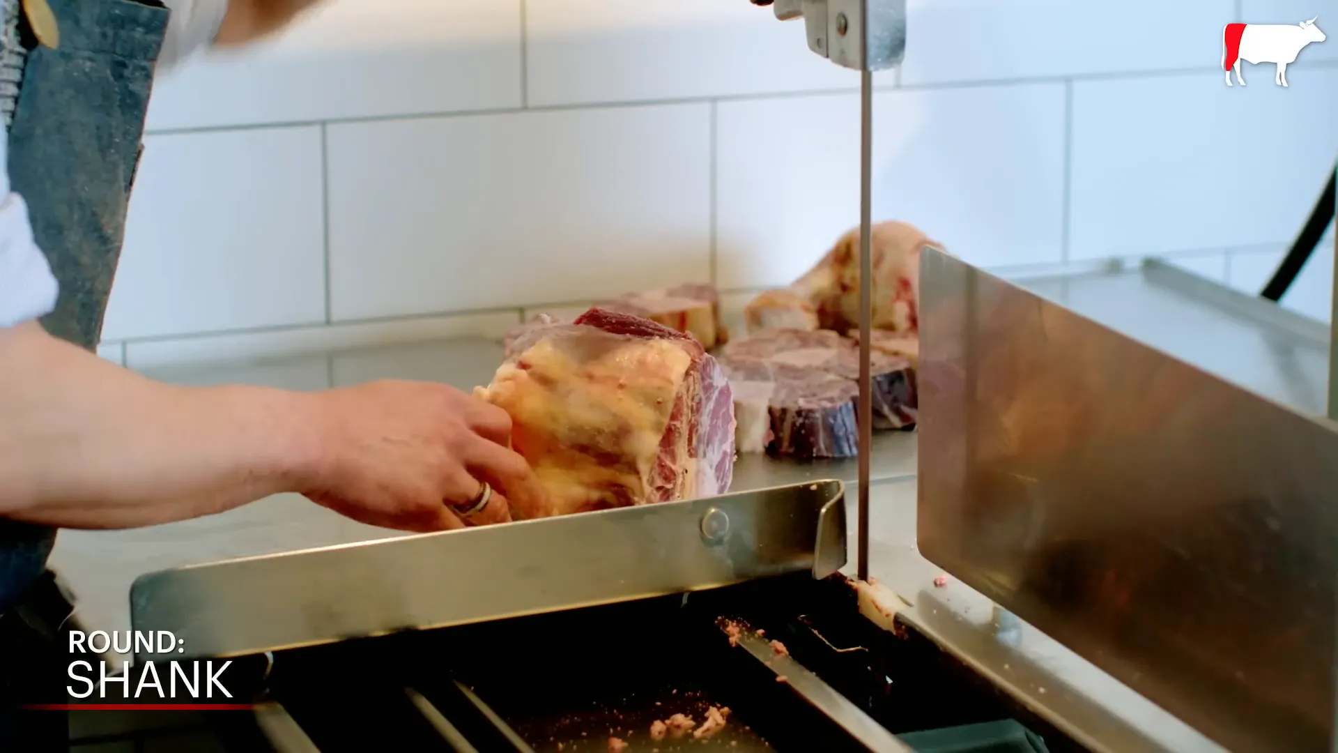 Cutting osso buco with a band saw for perfect braising pieces