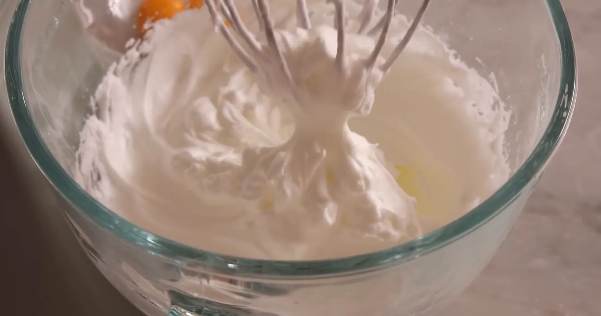 Whipped egg whites forming stiff peaks