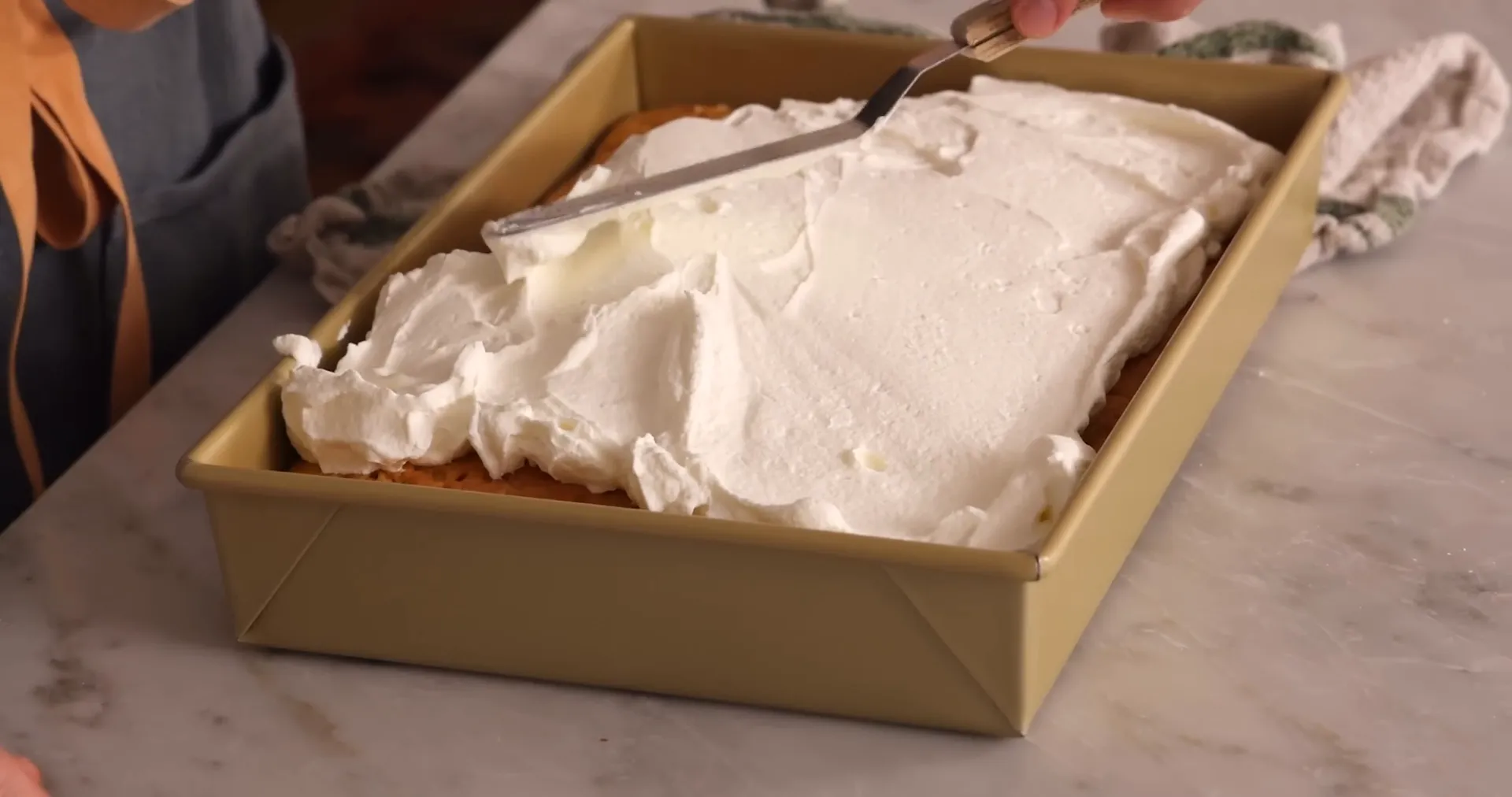 Swooping whipped cream topping on the tres leches cake
