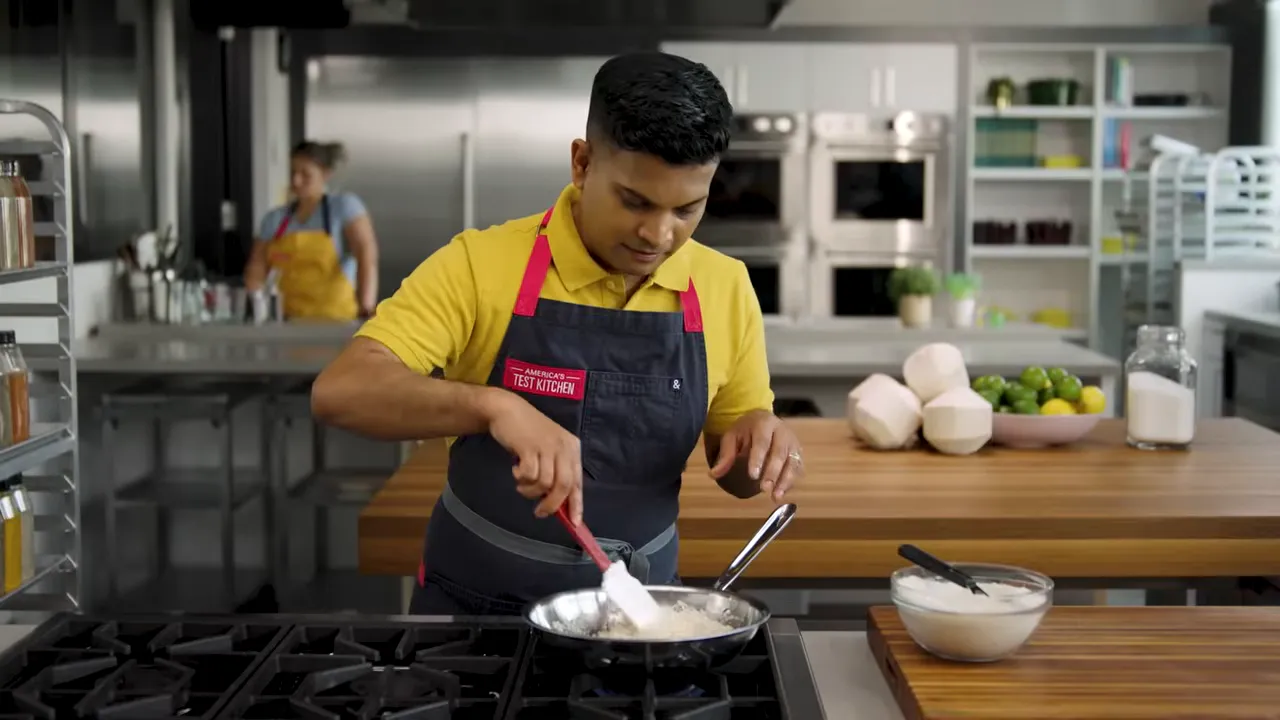 Chef stirring pan with young coconuts and bowl of coconut milk on counter