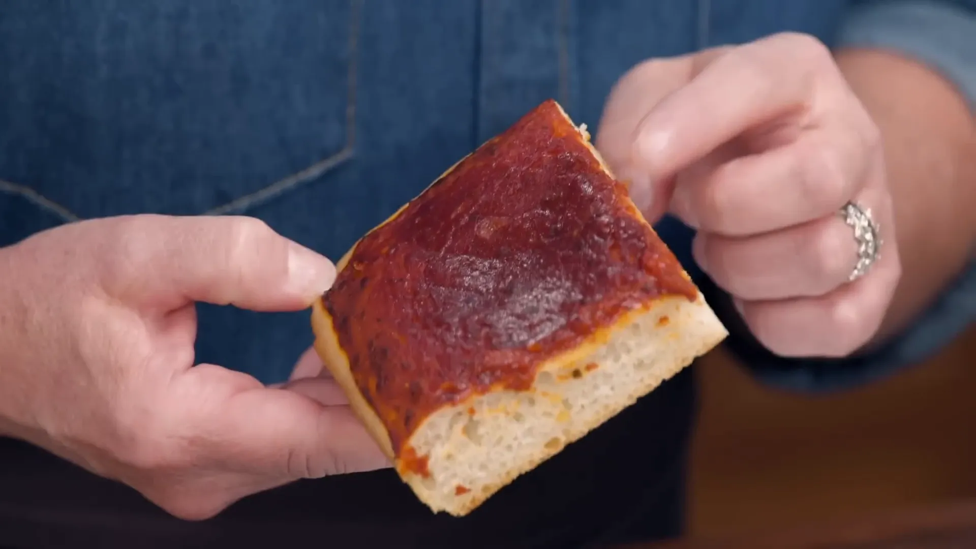 Close-up of tomato pie slices showing soft crumb and sauce