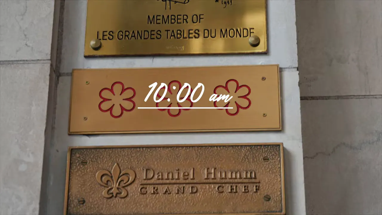Restaurant entrance plaques with three-star motif and an overlaid '10:00 am' time graphic