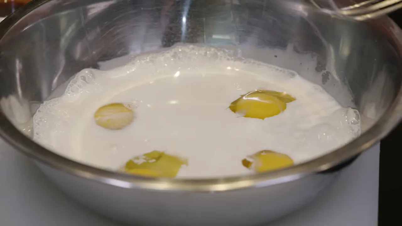 eggs and half-and-half in stainless mixing bowl
