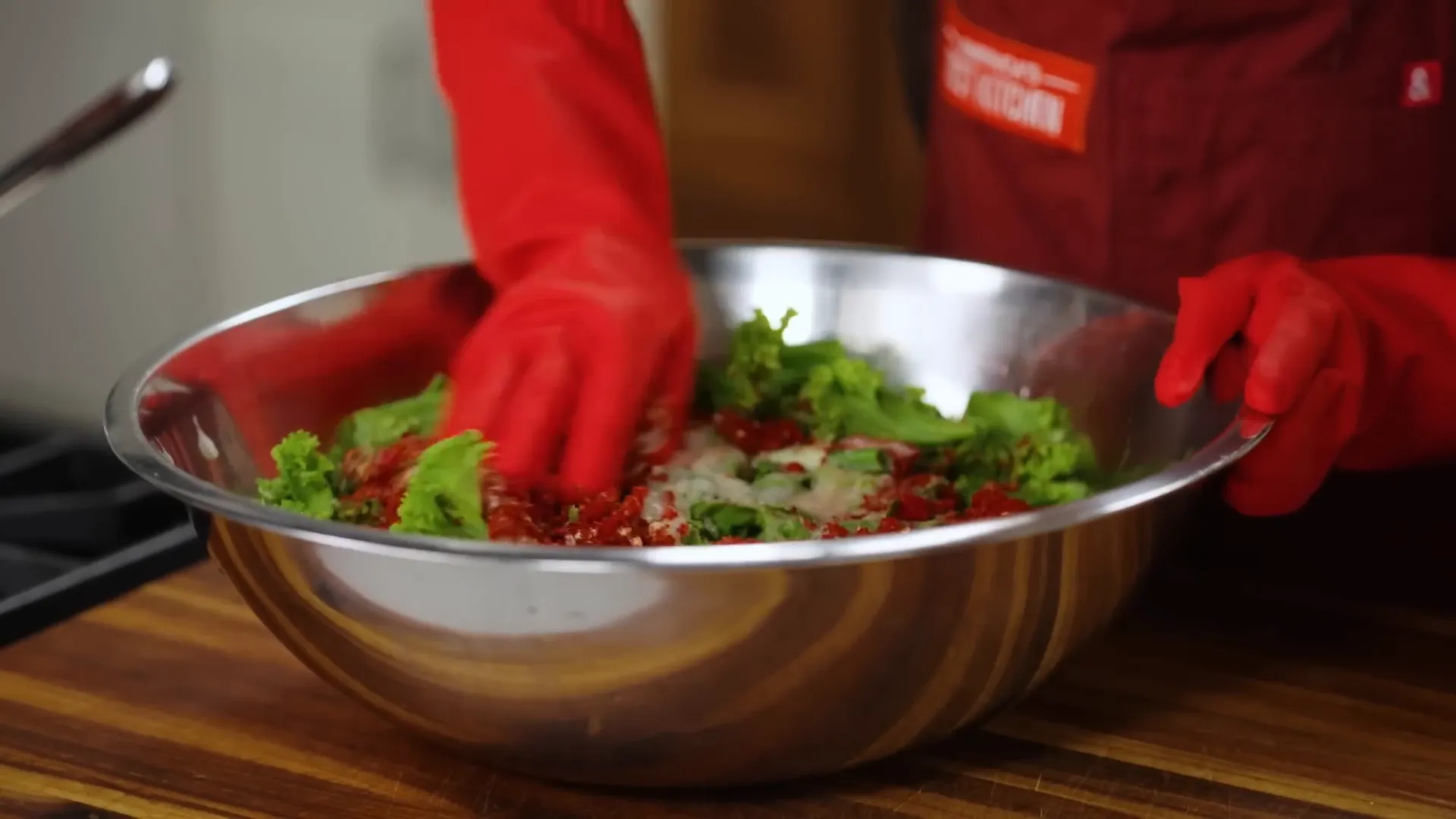 Mixing kimchi seasoning into cabbage with hands
