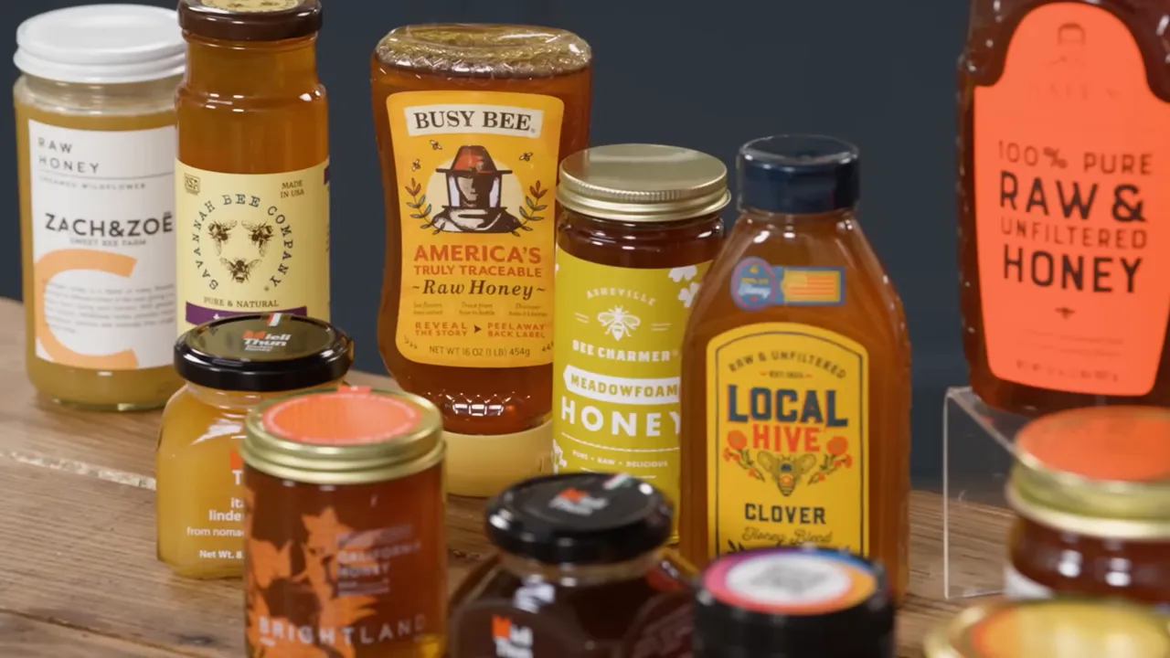 Assortment of grocery-store honey jars on a wooden surface, including bottles labeled raw and local varieties