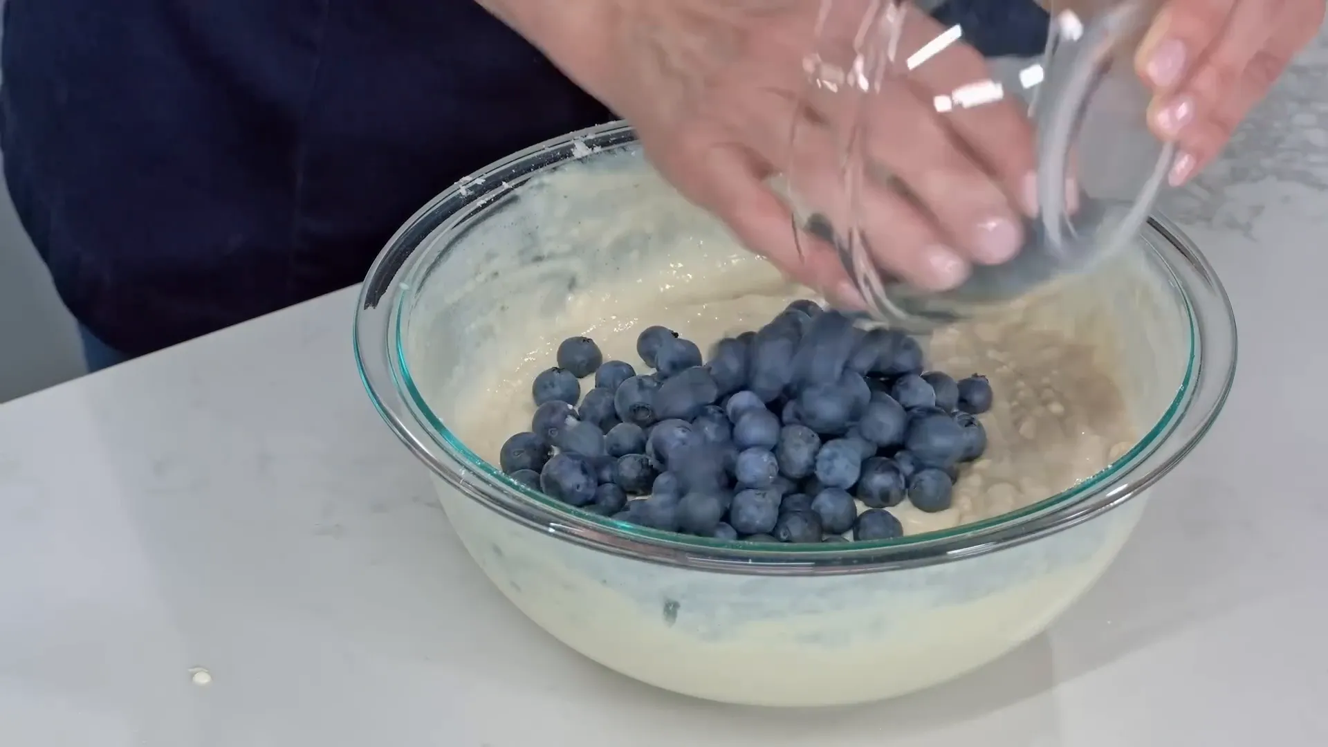 Adding fresh blueberries to pancake batter