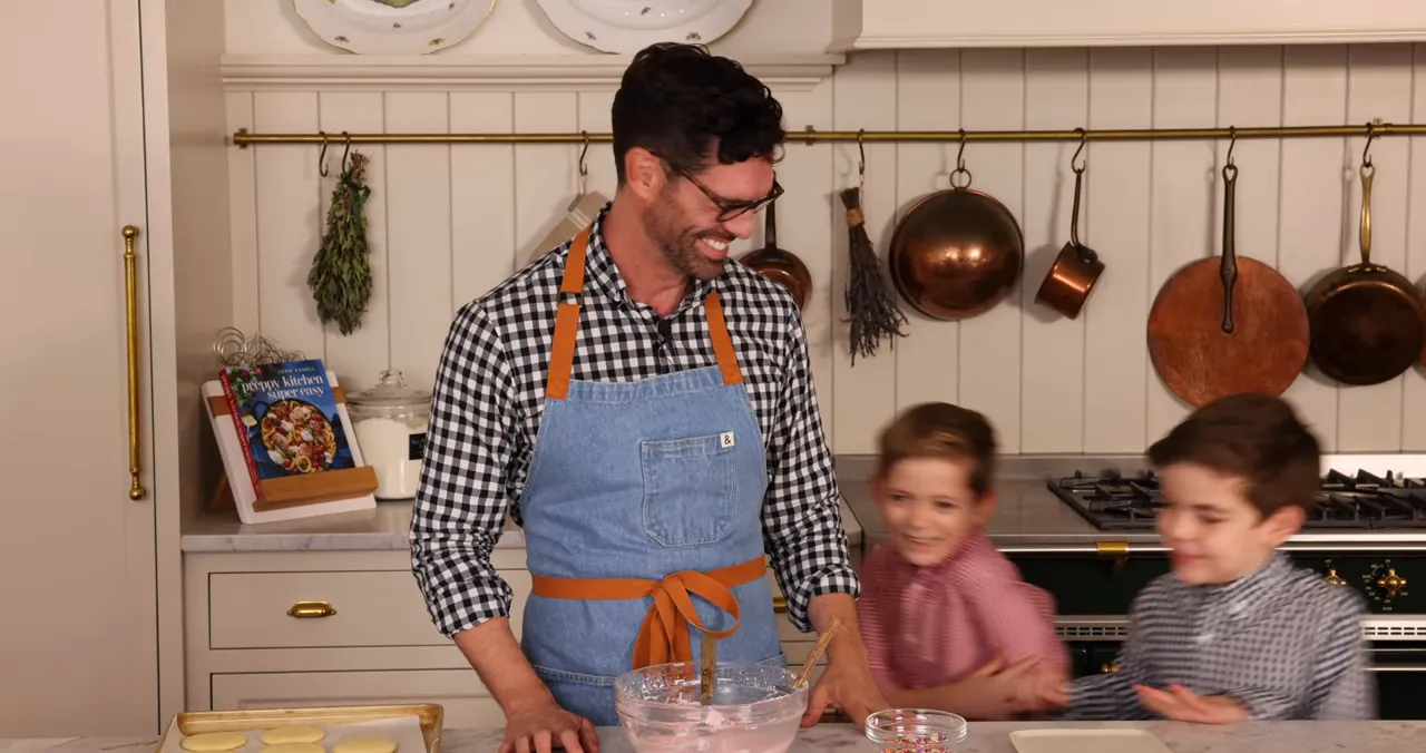 Mixing pink buttercream in a medium bowl