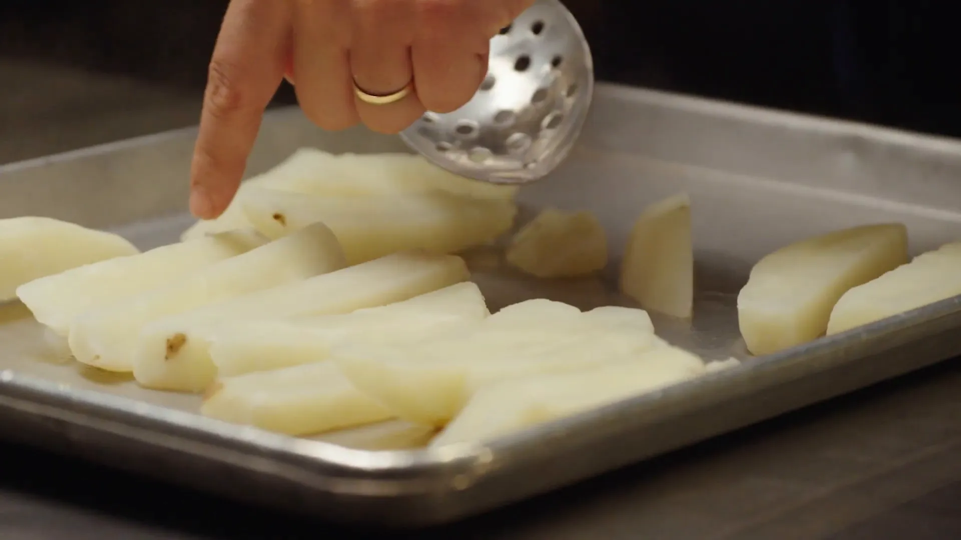 Boiled potatoes cooling on a tray with soft, fluffy edges