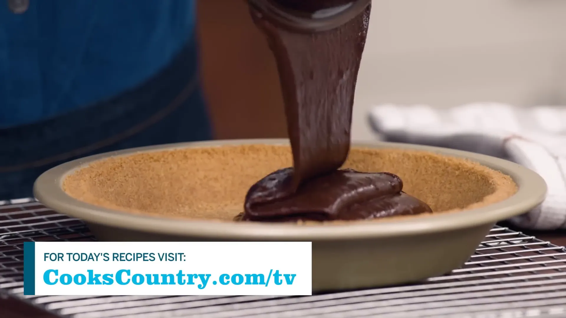 Pouring brownie batter into graham cracker crust