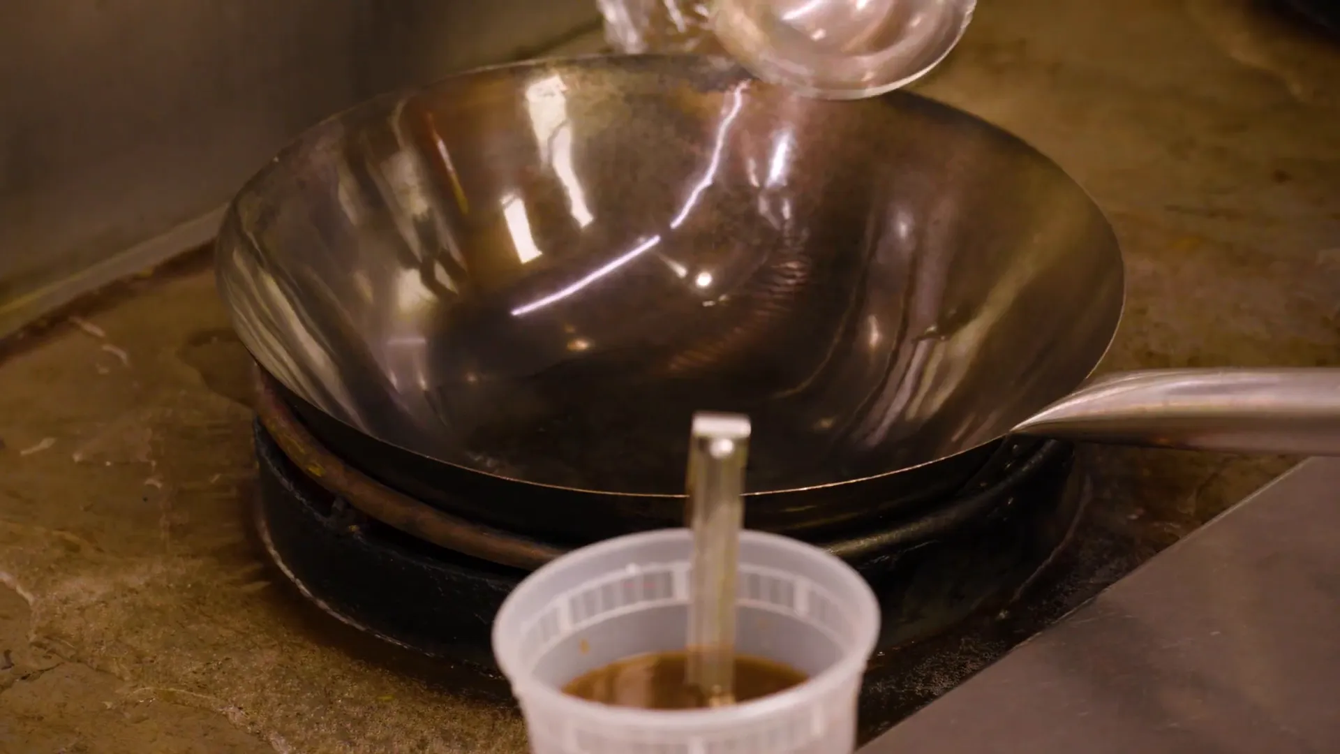 A pot with pad thai sauce simmering to a syrupy consistency