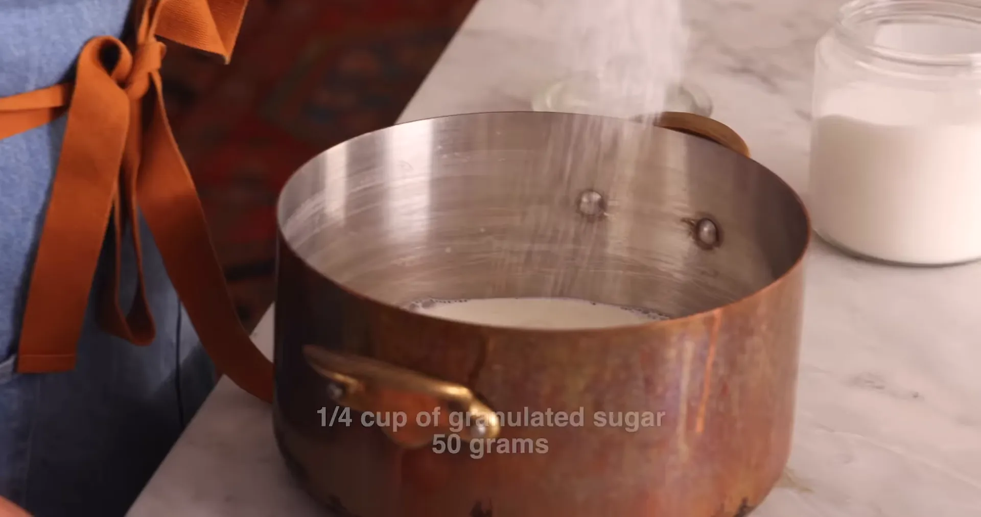 Milk and sugar heating in a large pot