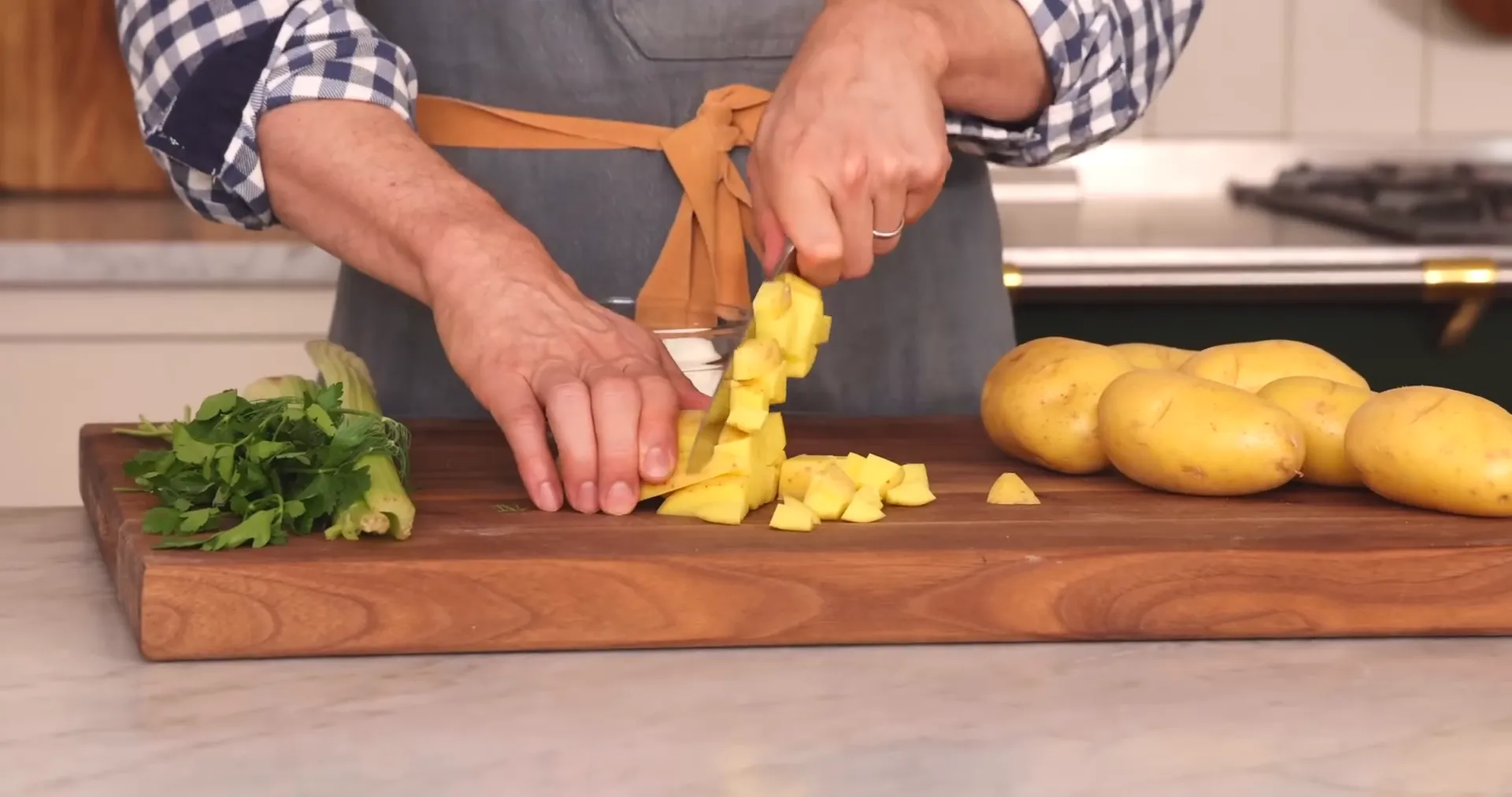 Cutting potatoes into one inch pieces