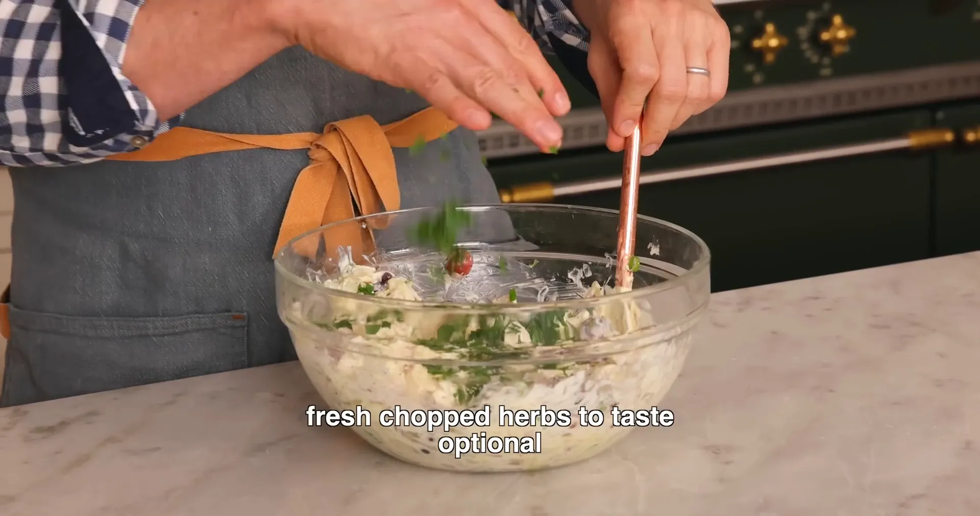 Adding fresh parsley to chicken salad as a finishing touch