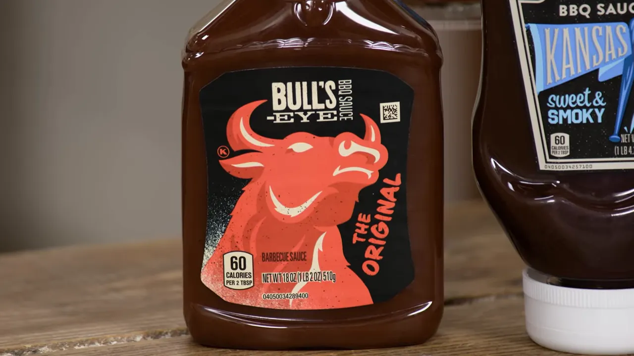 Close-up of a Bull’s‑Eye BBQ sauce bottle showing the red bull logo and label reading 'Bull's Eye The Original'.