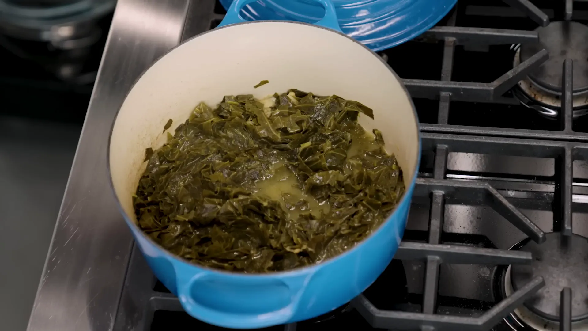 Dark glossy braised collard greens with chopped ham hock meat stirred in