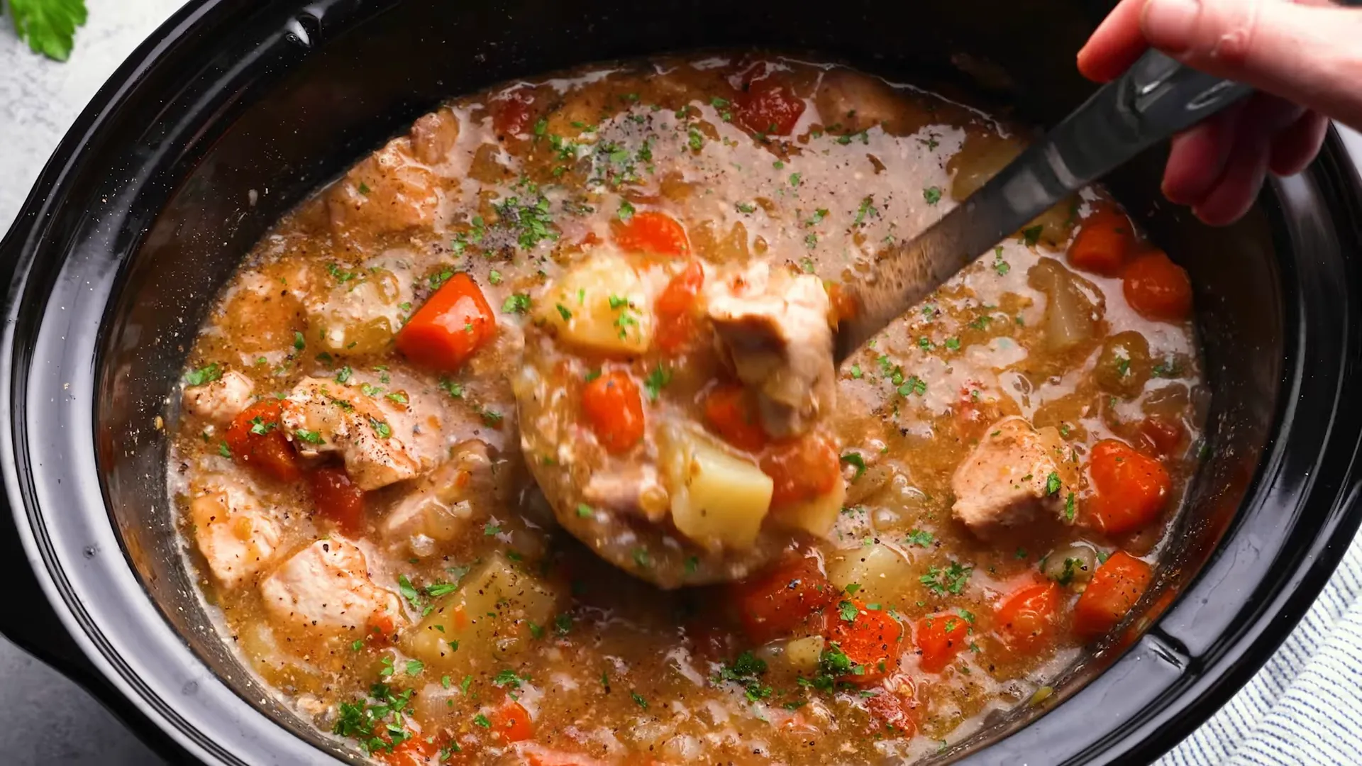 Finished green chile pork stew garnished with parsley