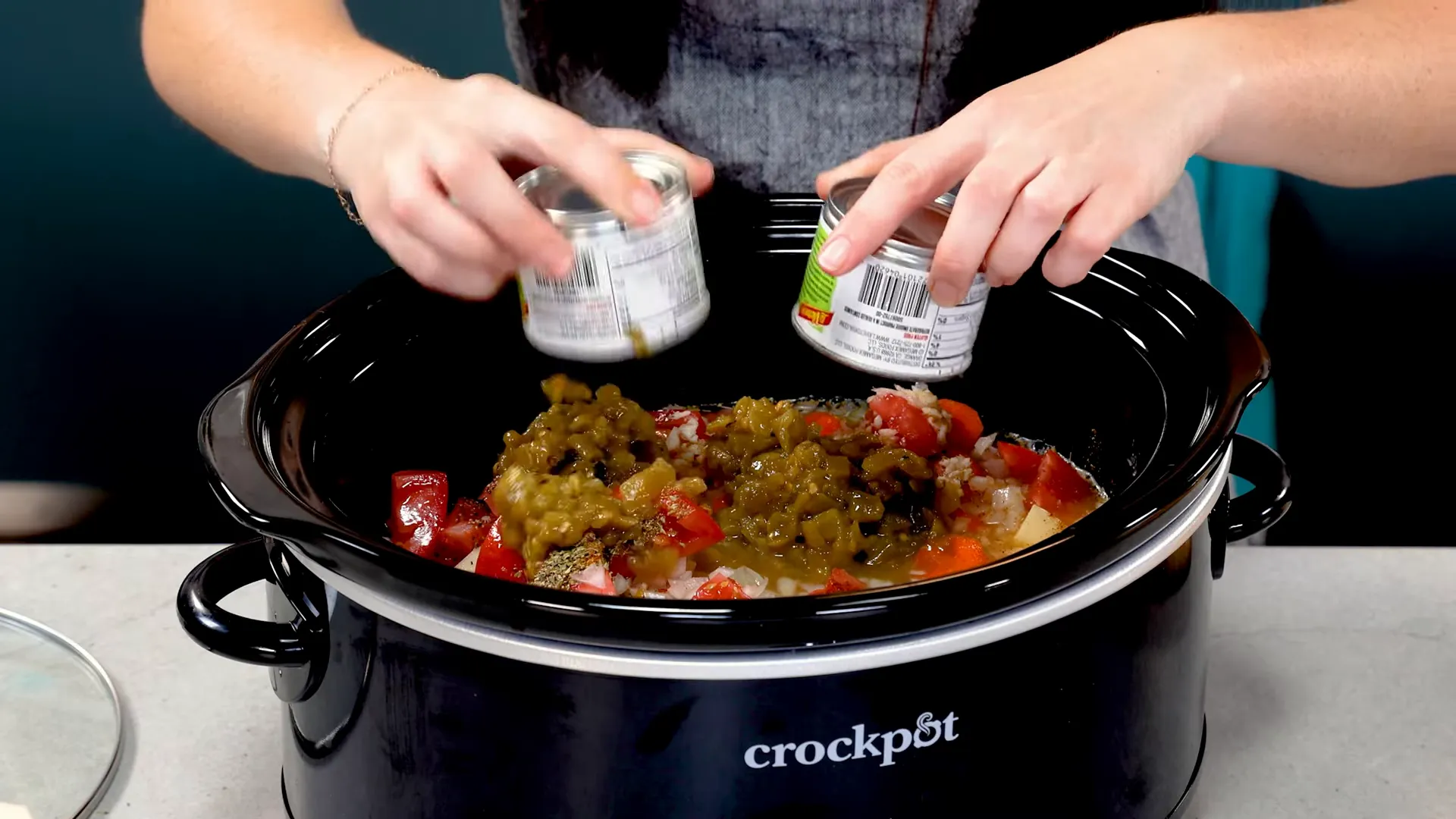 Adding diced green chiles to the stew