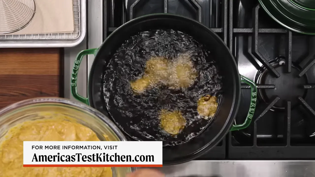 Chicken pieces frying in hot oil, sizzling