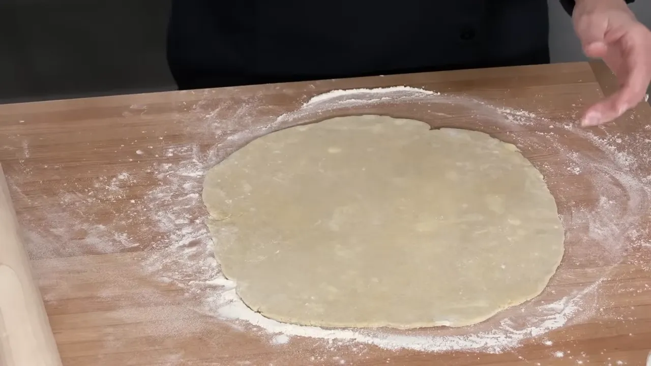 Rolling the chilled pie dough to a 12-inch round
