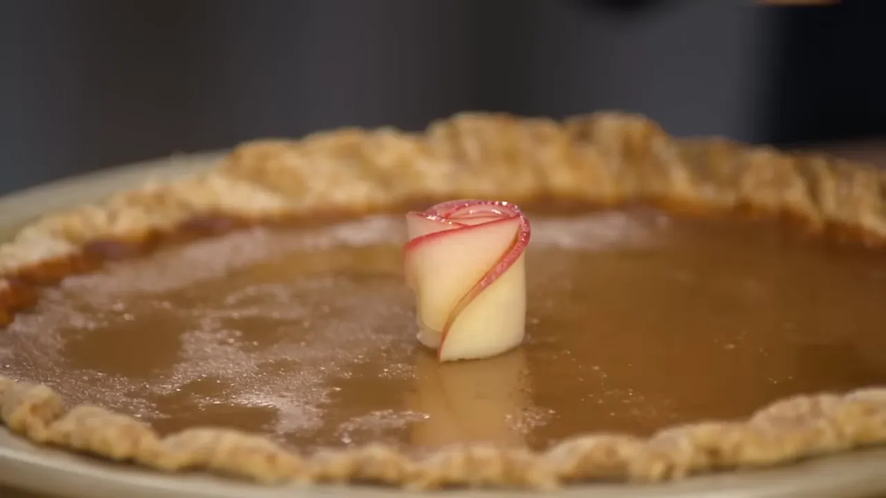 Delicate apple slice rosettes arranged atop the pie