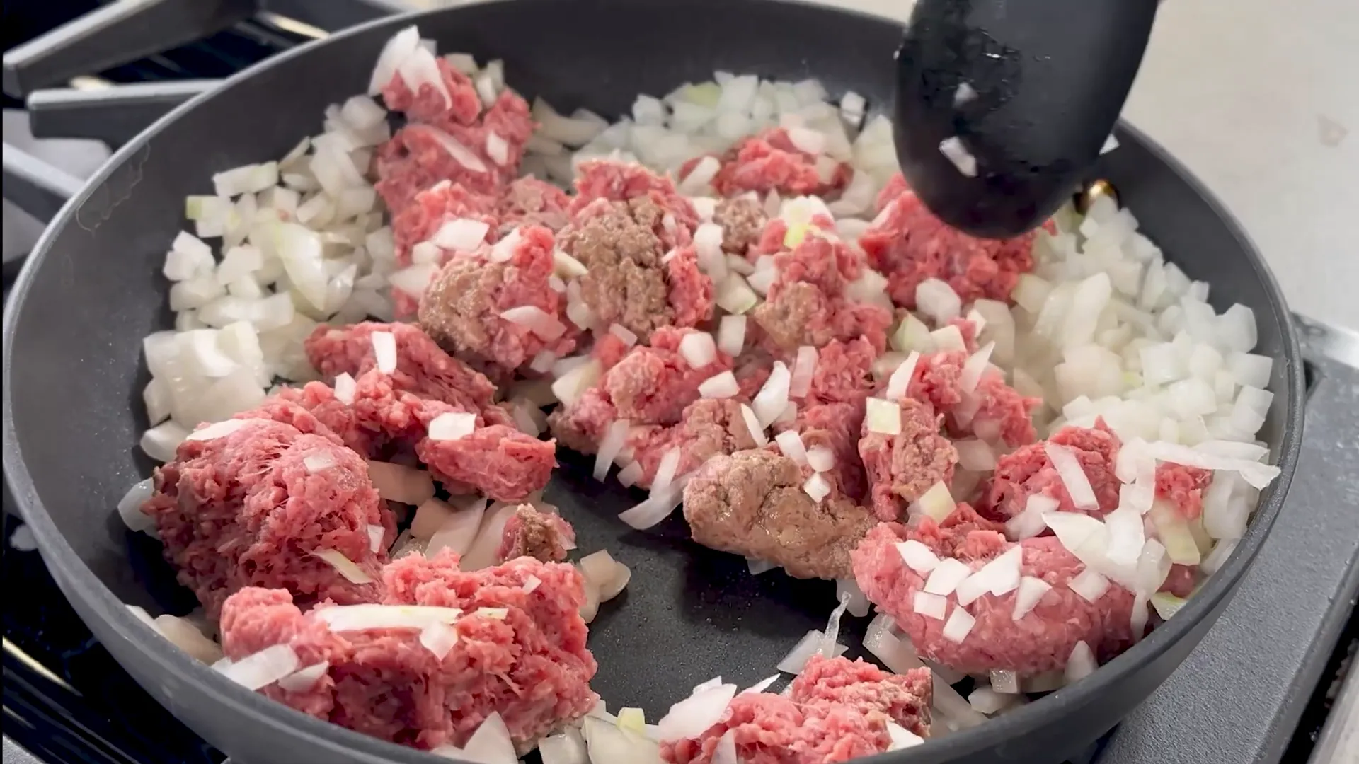 Cooking ground beef and onions in skillet