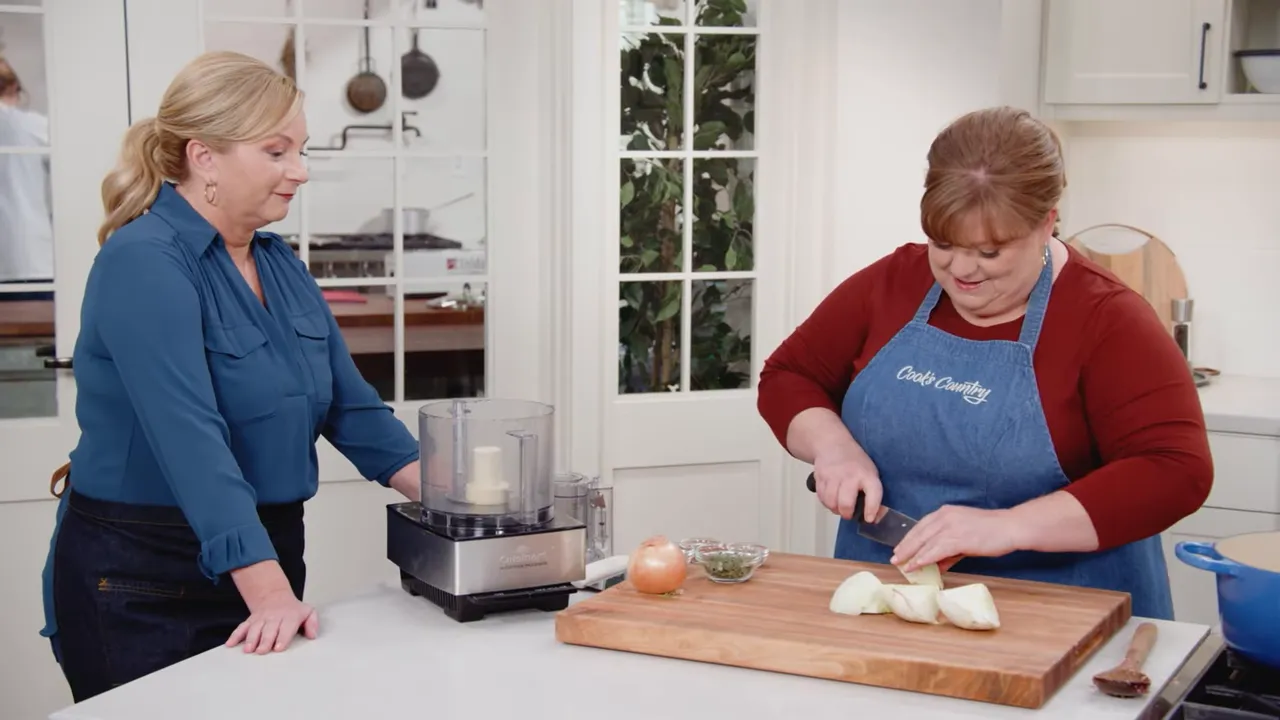 cook chopping fennel next to a food processor to make a sofrito