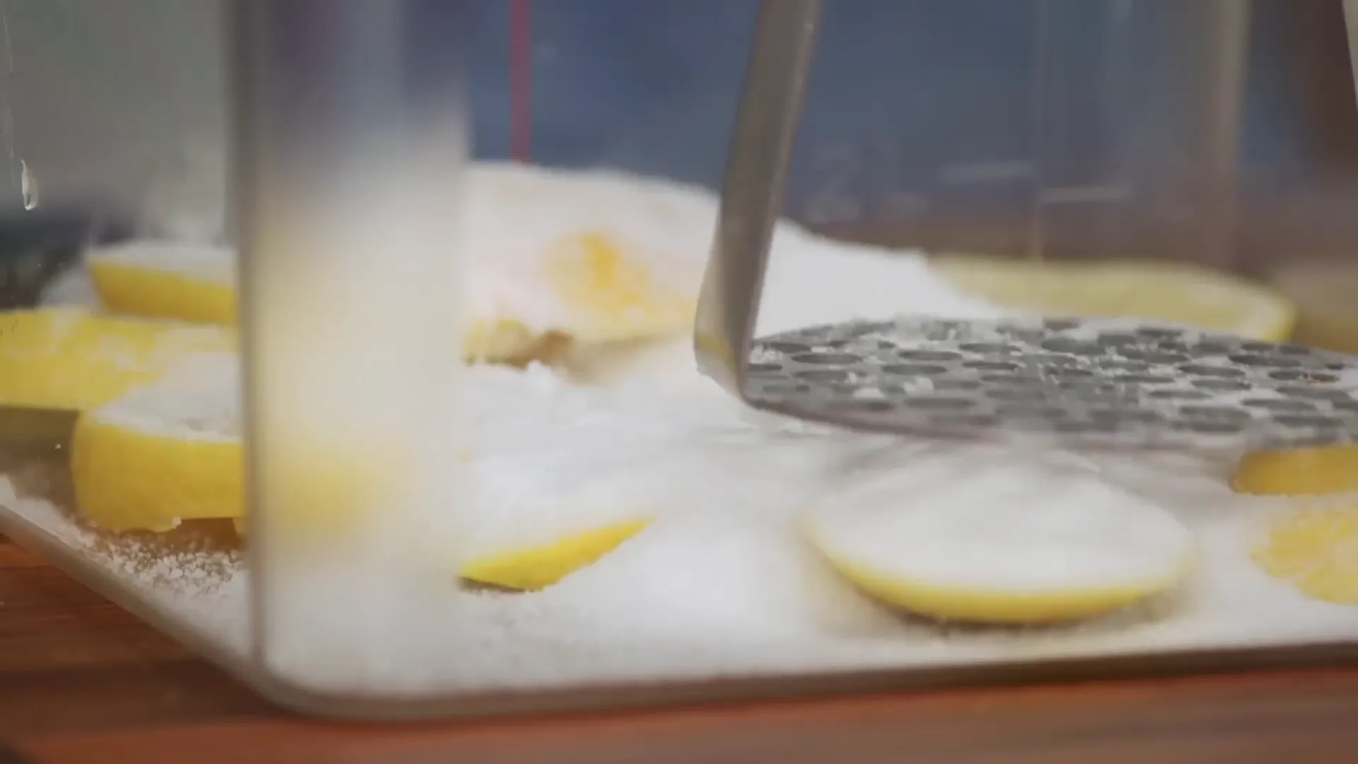 Muddling lemon slices with sugar