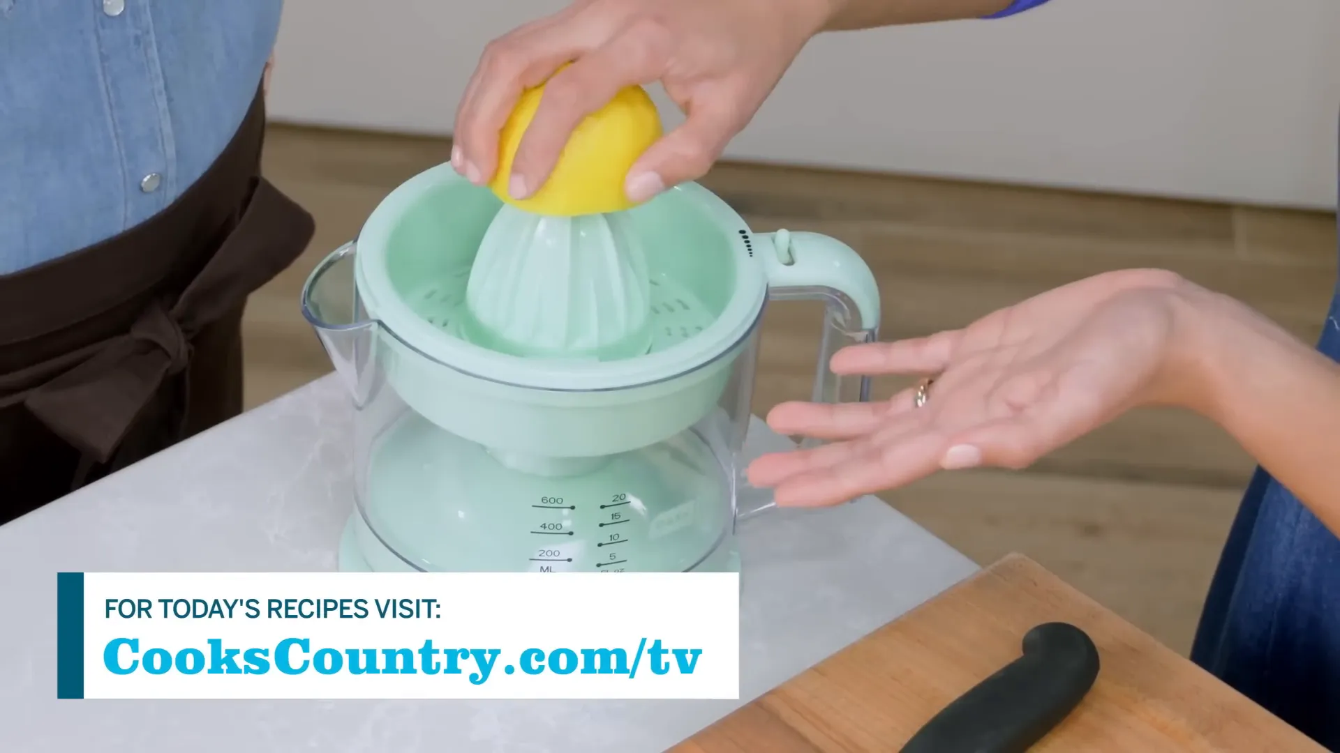 Juicing fresh lemons with electric juicer