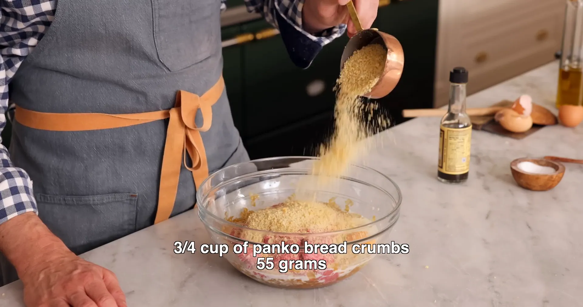 Mixing ground beef with seasonings and breadcrumbs