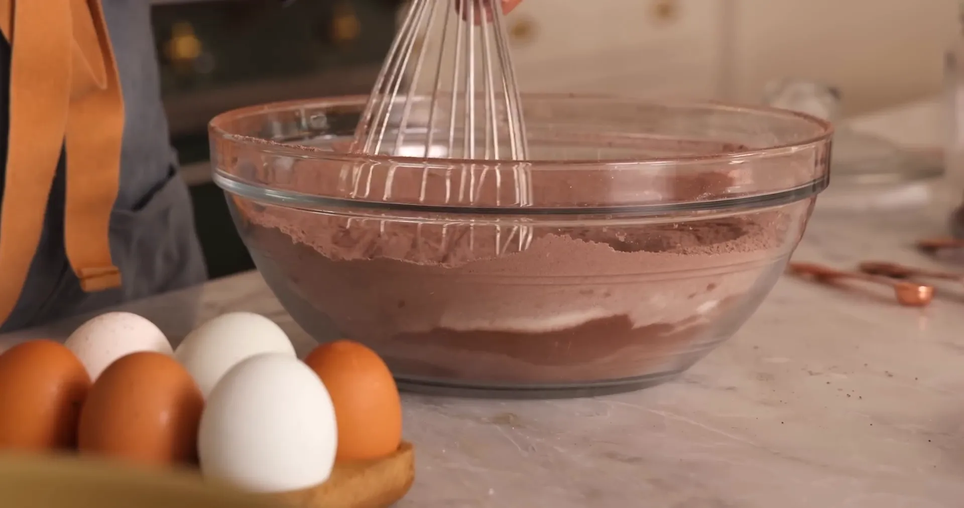 Sifting cocoa powder into the dry ingredients