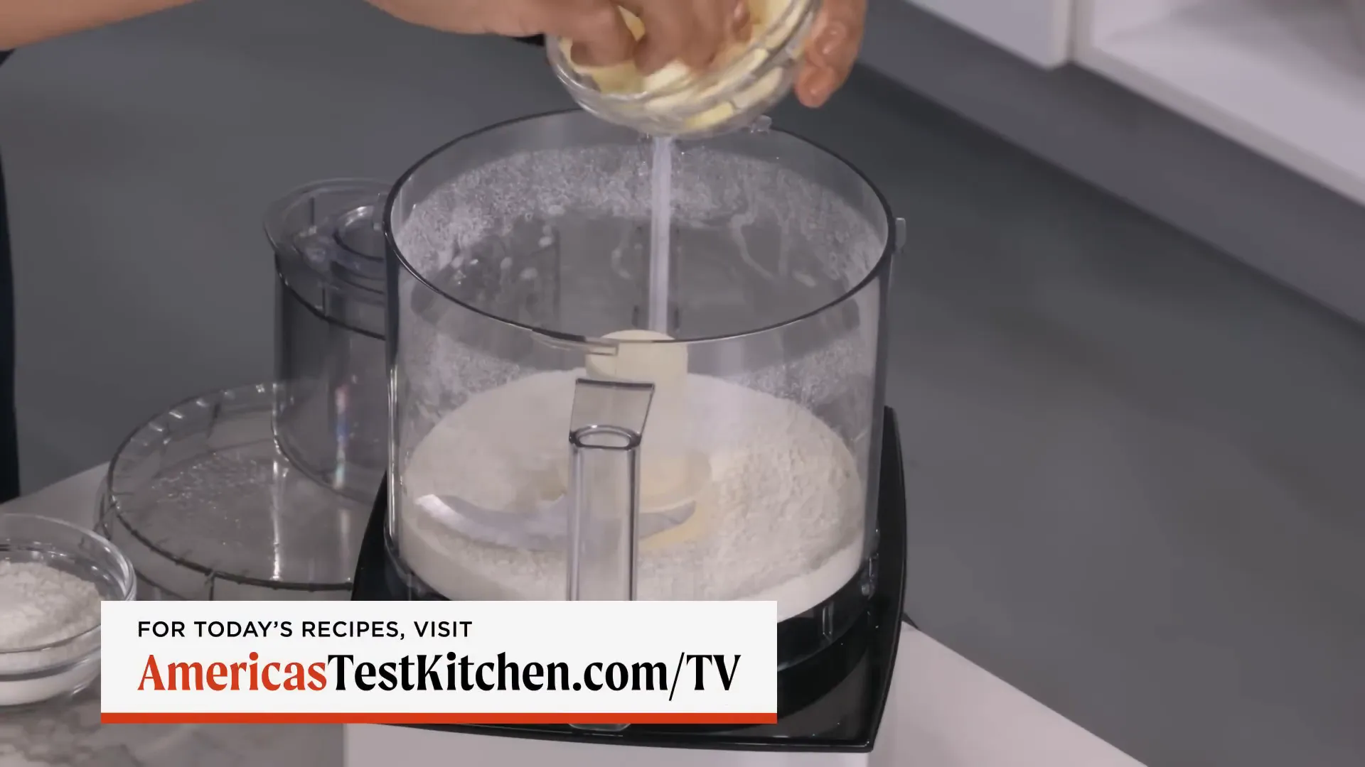 Butter being pulsed into flour to create a cornmeal-like texture